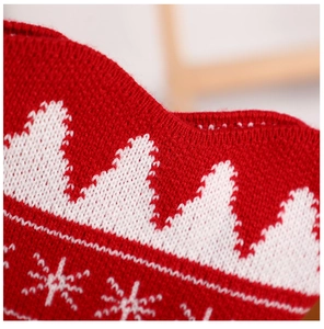 Close-up of red and white knitted Christmas bone stocking showing detailed fabric texture