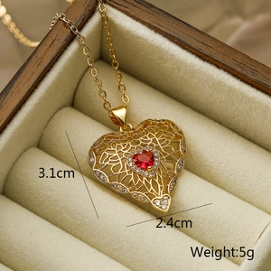 Macro shot of 18k gold plated necklace with red heart gemstone and clear zircon accents