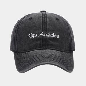 Detailed view of Los Angeles white embroidery on washed black denim baseball cap fabric