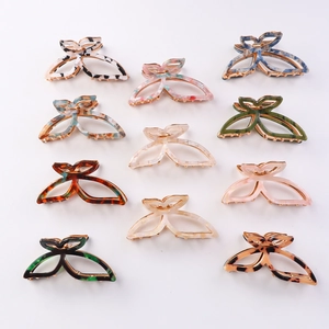 Elegant butterfly hair claws in diverse marble patterns and colors on white background