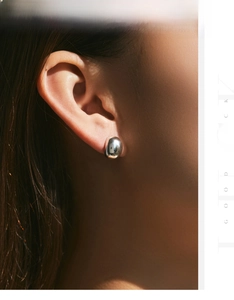 Detailed view of polished S925 sterling silver bean-shaped earrings with a mirror finish