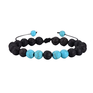 Detailed shot of adjustable macrame closure on lava rock and turquoise bead bracelet