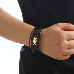 Men's multilayer black braided leather bracelet with golden fishbone accent on wrist