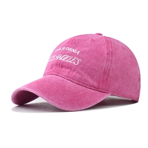 Close-up of Los Angeles white embroidery on pink washed cotton vintage baseball cap