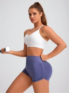 Women's seamless peach lift yoga set with white sports bra and high-waisted purple shorts