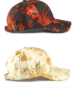 Detail of Chinese style floral brocade baseball caps with intricate silk embroidery texture