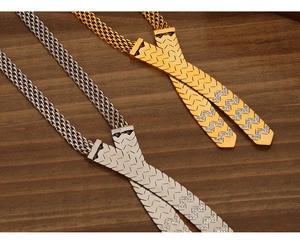 Close-up of gold and silver crossover V-shaped pendant necklaces with shiny rhinestones