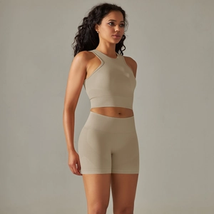 Detail of khaki seamless knit yoga set featuring halter crop top and high waist shorts