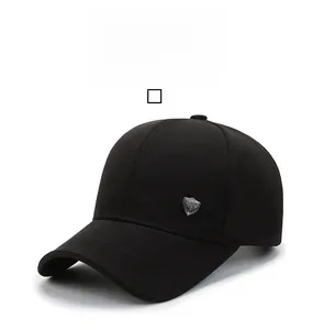 Detail view of a black baseball cap with Trends text and a silver shield logo accent