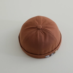 Detailed top view of dark brown cotton baby docker hat with cute animal embroidery