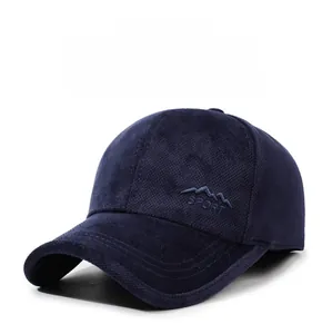 Detail showing deep blue baseball cap with mountain embroidery and waffle texture fabric