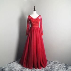 Detail of red V-neck evening gown featuring intricate sequins, beads and mesh sleeves