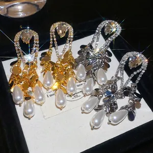 Gold plated water drop pearl earrings with rhinestones in a luxury jewelry box