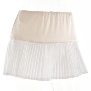 Detailed view of white pleated mini skirt with satin top panel on mannequin