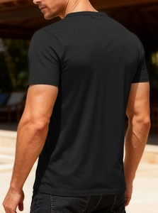 Rear view of breathable black V-neck t-shirt showing tailored fit on a male model outdoors