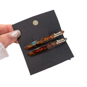 Minimalist amber tortoiseshell hair clips with Barrette La France gold lettering for women