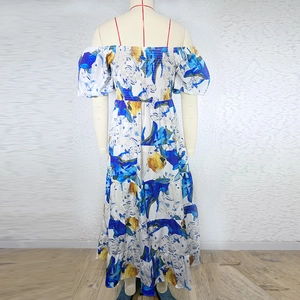 Detail of floral puff sleeve dress featuring ruffled bust and layered tiered skirt
