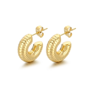 Elegant gold ribbed C-shape hollow stud earrings with a sleek French croissant style texture