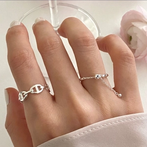 Close-up of 925 sterling silver chain link ring and minimalist long tassel drop ring