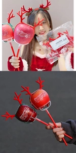Close-up of red crystal reindeer horn sticks for DIY Christmas apple bouquet decoration