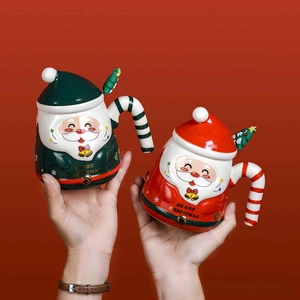 Close-up of ceramic Santa mug with festive candy cane handle and Christmas tree lid