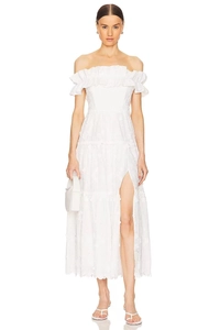Detail of off-the-shoulder ruffle neckline and hollow embroidery on white maxi dress