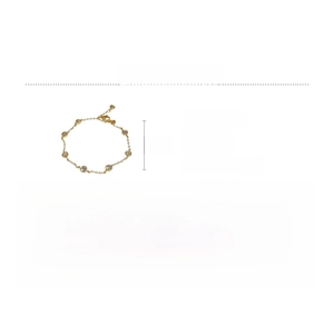Detail of a gold-plated copper bracelet featuring zircon inlays and a minimalist style