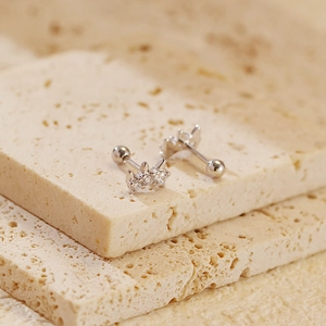 Macro view of S925 silver star stud earrings with zircon stones and screw-back ball closure