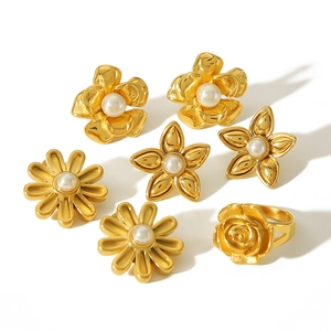 18k gold floral earrings and ring set with pearls on a clean white background