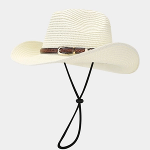 Close-up of beige woven straw hat with brown leather belt buckle strap and windproof cord
