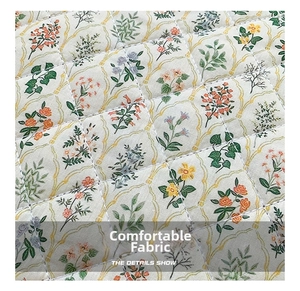 Close-up of quilted floral fabric texture for laptop sleeve with diamond stitching pattern