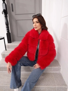 Close-up of bright red faux fox fur jacket texture with plush striped pattern details