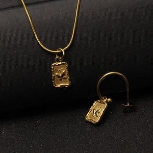 Golden butterfly pendant necklace and C-shape earrings set in polished stainless steel
