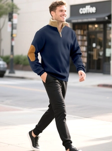 Detail of navy blue half-zip sweatshirt with khaki contrast collar and elbow patches