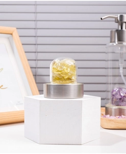 Detailed view of natural citrine crystals inside a glass soap dispenser base with metal finish