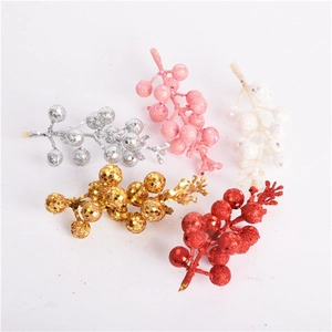 Close-up of assorted glitter artificial berry stems in gold, red, silver, pink, and white