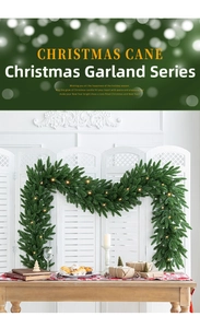 Detail of green Christmas garland with warm LED lights on a rustic wooden table setup