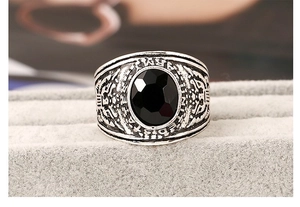 Macro view of vintage US Army ring featuring large black oval gem and eagle relief
