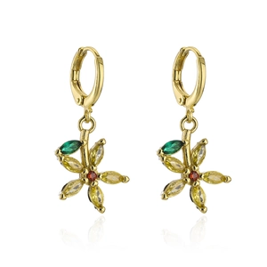 Macro detail of 18K gold floral earrings with vibrant zircon stones on a white base