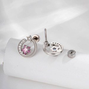 Micro-set zircon star and moon stud earrings with pink and blue stones on white silk