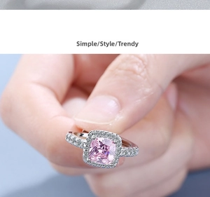 Macro shot of square pink gemstone ring with micro-paved cubic zirconia on silver band