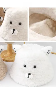 Close-up of fluffy white bear bucket hat showing soft fleece texture and cute ear details
