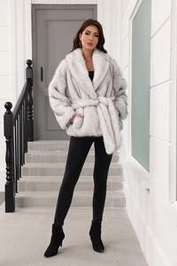 Detailed view of grey faux fur coat with waist belt and thick textured sleeves