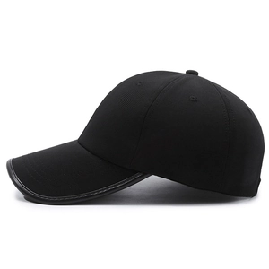 Classic black baseball cap with contrast piping and textured fabric on a white background