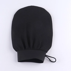 Detail view of black exfoliating scrub mitt with elastic cuff and hanging loop design