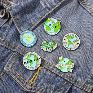 Eco-friendly earth enamel pins set on denim with 'There is no Planet B' slogans