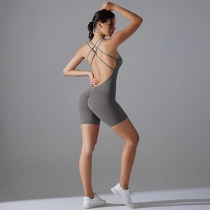 Macro detail of dark grey yoga romper showing criss-cross back straps and ruched butt lifting