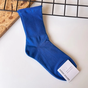 Royal blue ribbed cotton crew socks for women featuring minimalist rolled edge design