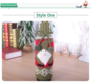 Detail of knitted Santa wine bottle cover with festive green ties and soft pom-poms