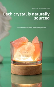 Macro shot of orange crystal stone diffuser with wood base and glass container
